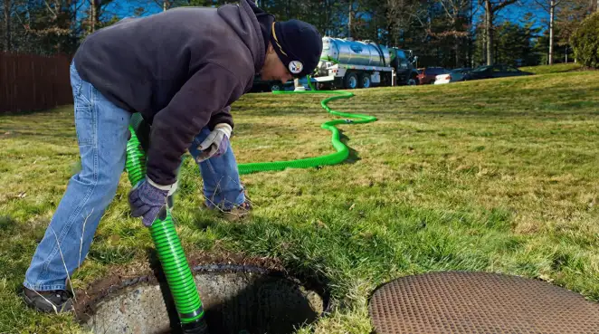 Service technician performing residential septic pumping and drainage maintenance in Akron, OH